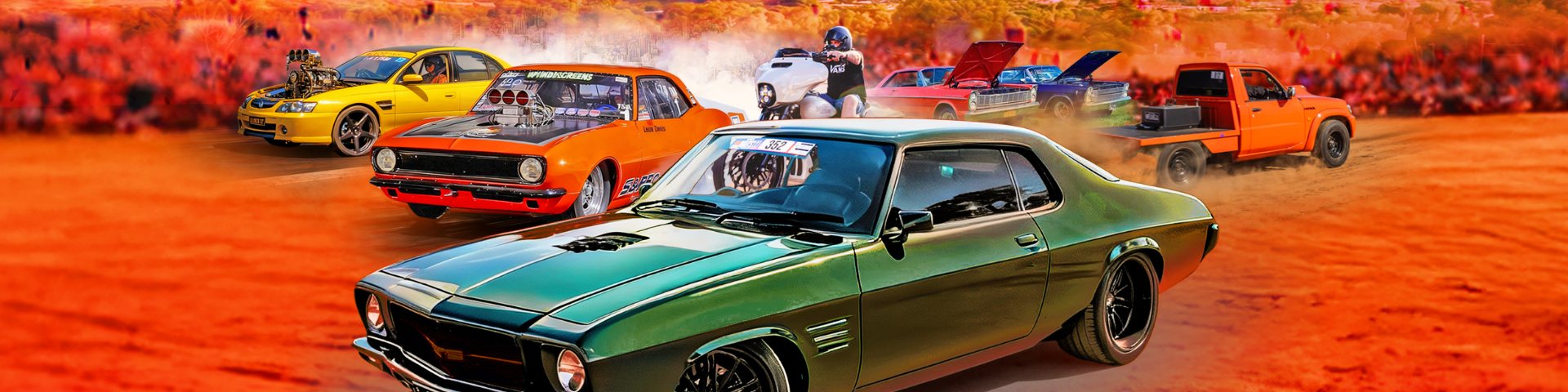 Lineup of modified cars and utes -- yellow, orange and green coupes, a motorcyclist, and an orange ute -- kicking up dust on red desert ground.